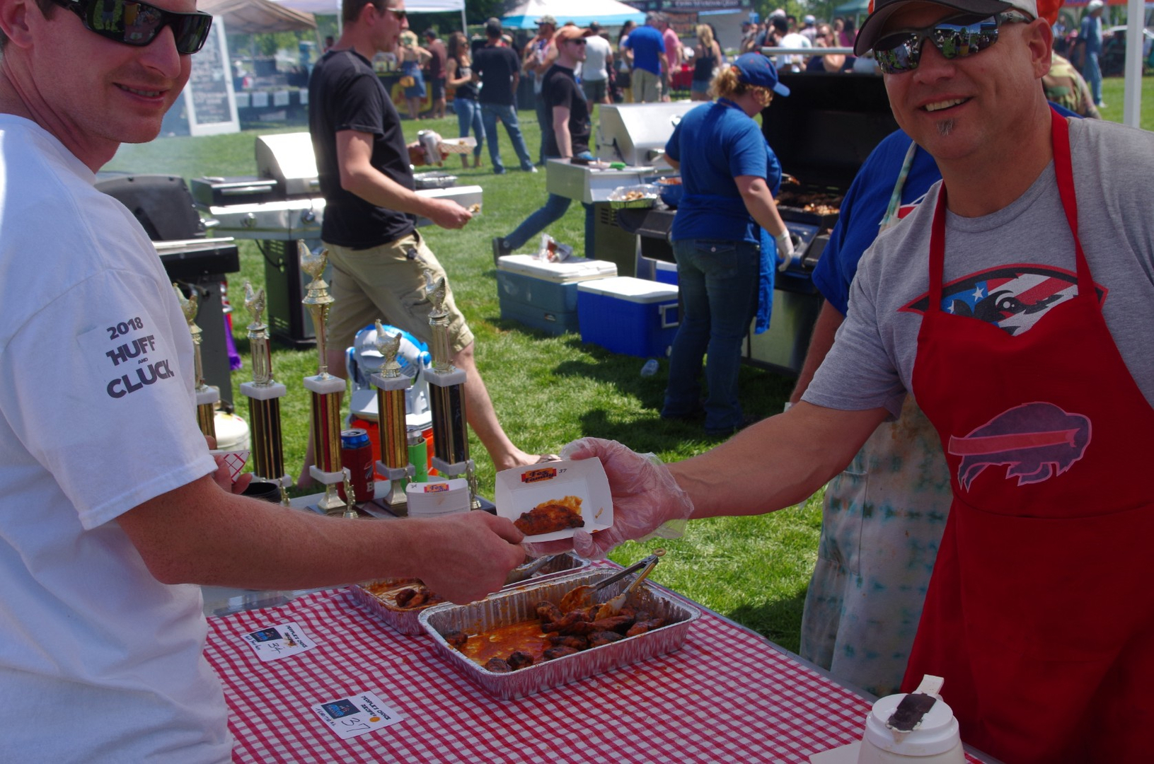 Wing-Off Cook handing customer wings